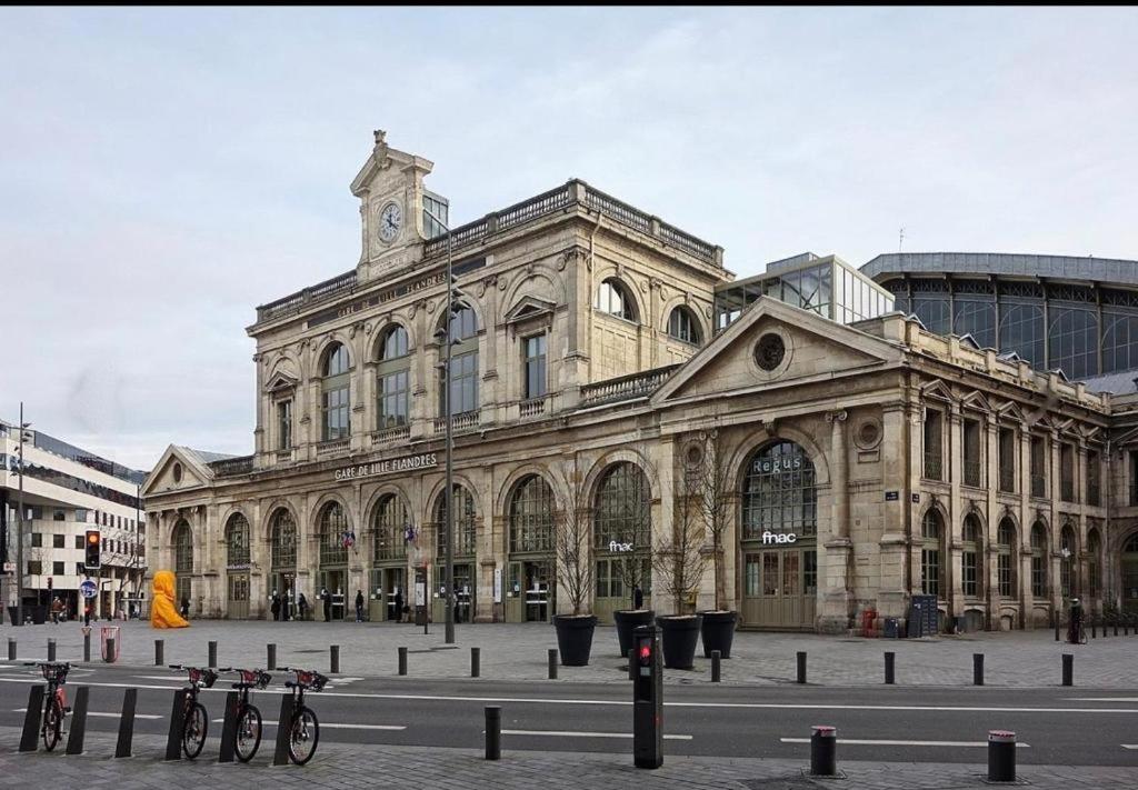 a large building with a clock tower on top of it at Appartement typique Gare Lille Flandre centre ville in Lille