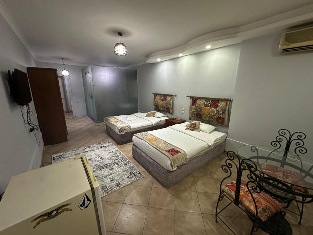 Postel nebo postele na pokoji v ubytování Arabesque Hotel
