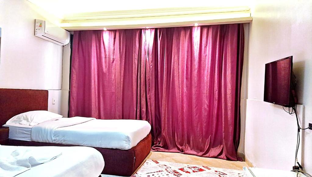 Postel nebo postele na pokoji v ubytování Arabesque Hotel