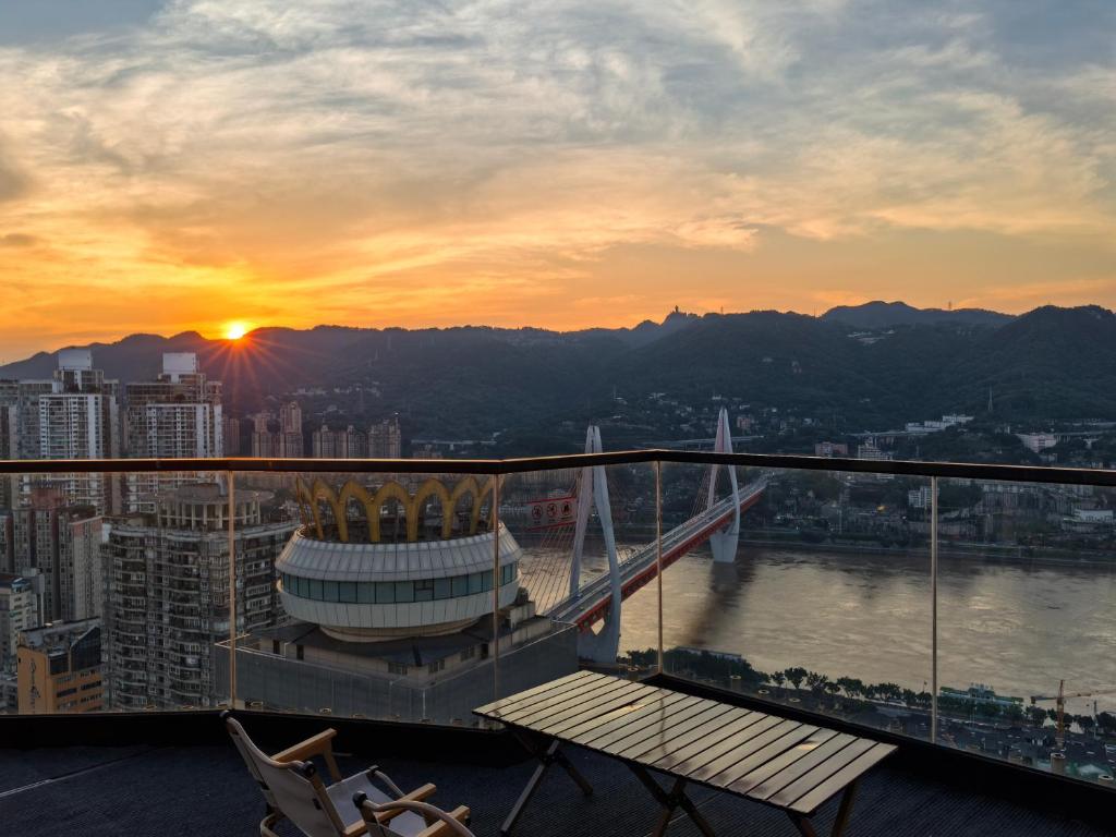 a view of the sunset from the balcony of a building at Yunqi River View Terrace Hotel in Chongqing