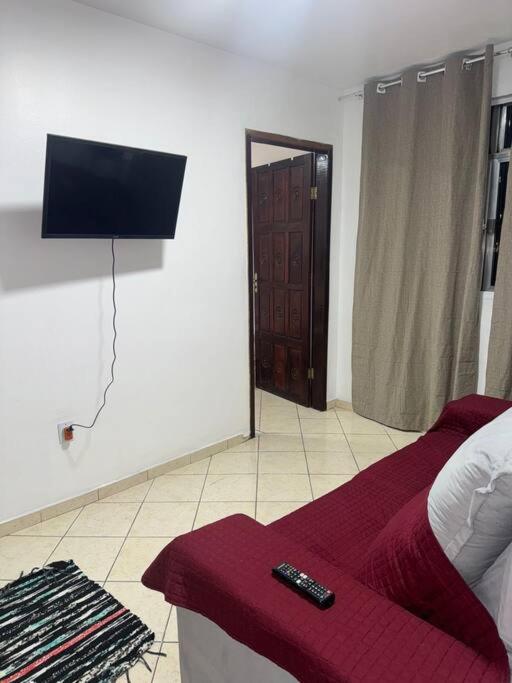 a bedroom with a bed with a remote control on it at Excelente apartamento no centro in Macaé