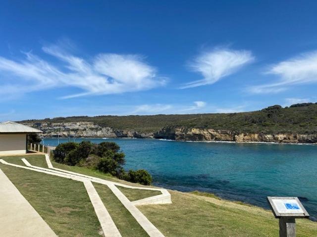 a view of a body of water with a building at Southern Ocean Motor Inn in Port Campbell