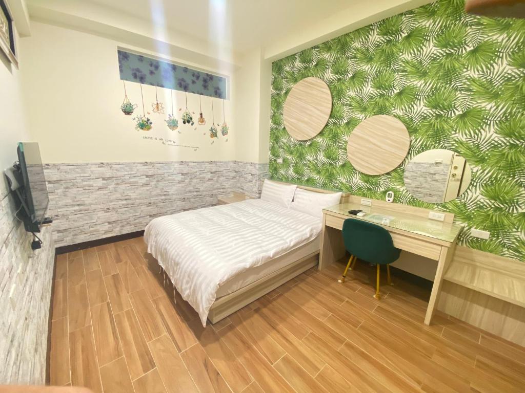 Postel nebo postele na pokoji v ubytování 台南迎家樂電梯民宿