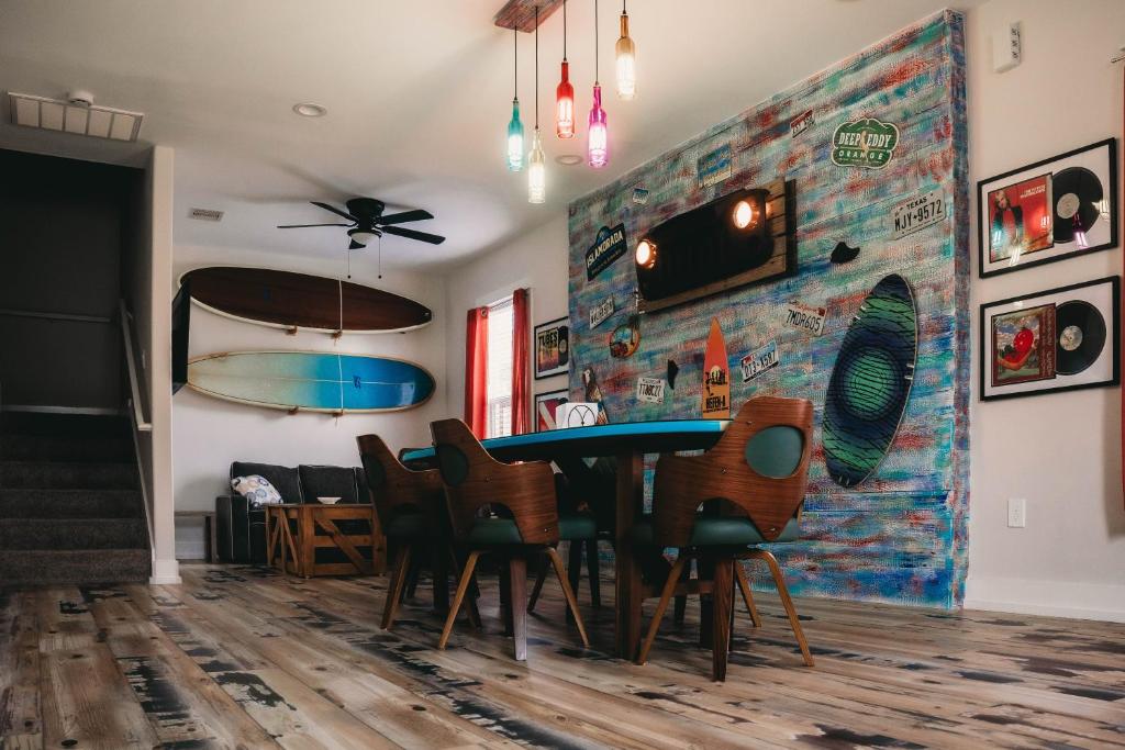 a dining room with a table and chairs at The Board House Longboard in Galveston