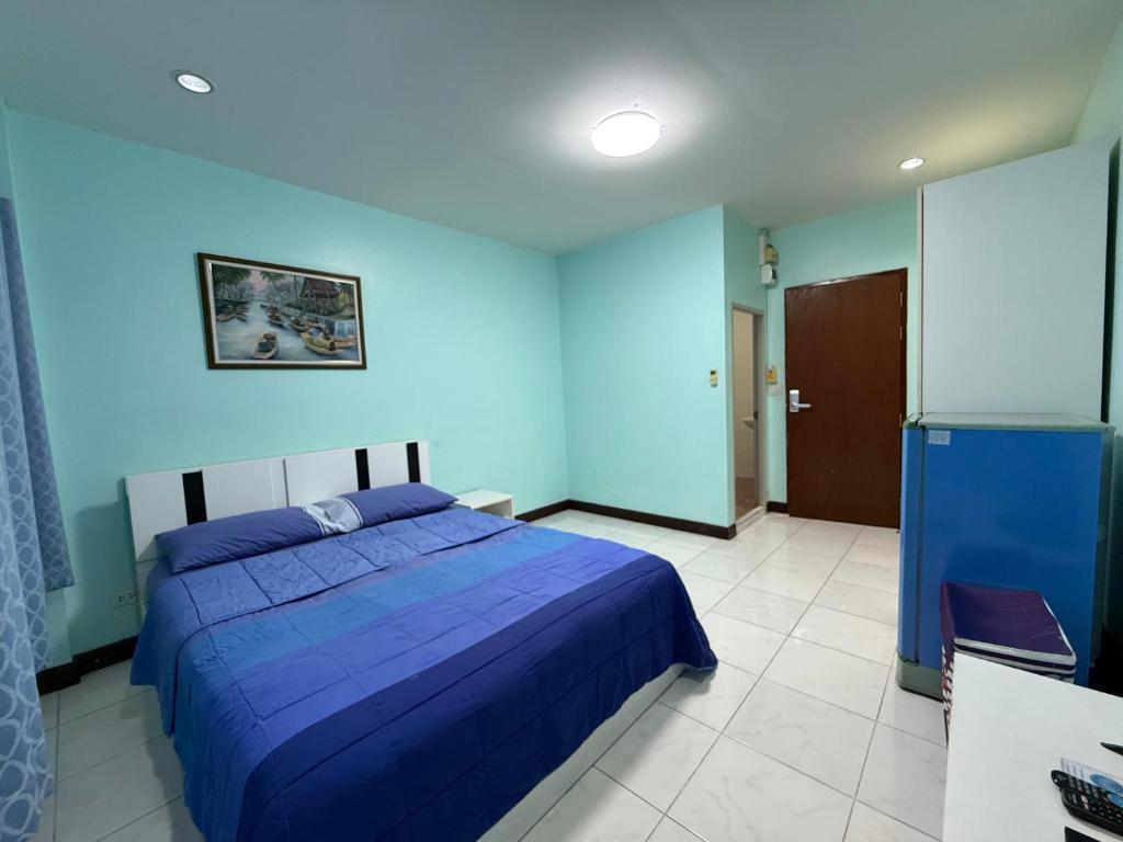 a blue bedroom with a bed and a blue wall at Best Rent a Room in Nai Yang Beach