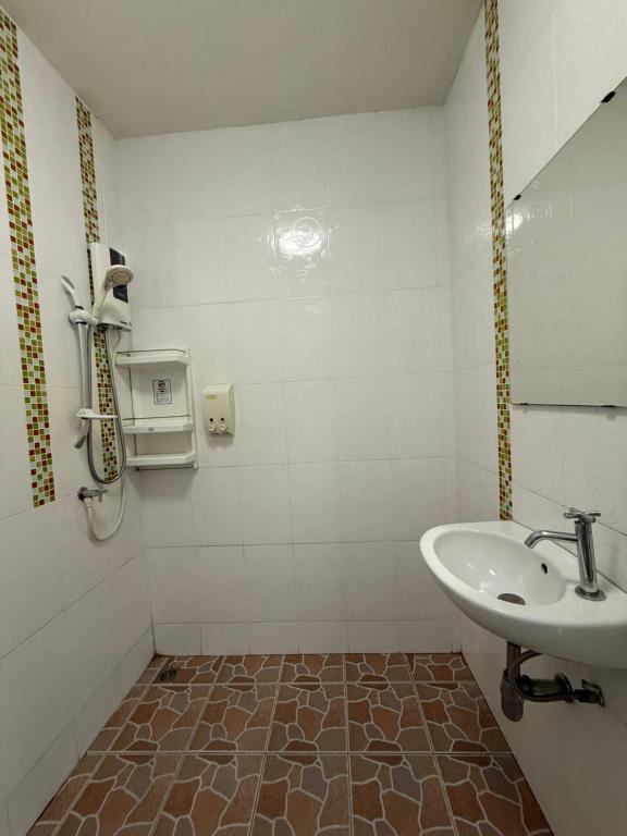 a bathroom with a sink and a mirror and a toilet at Best Rent a Room in Nai Yang Beach