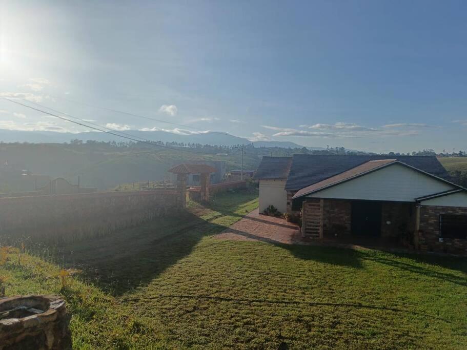 a view of a farm with a field and a house at Parcela Monte Alto Galería in Los Santos
