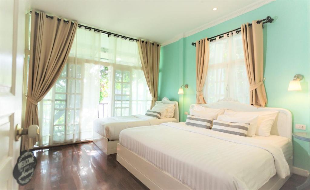 Postel nebo postele na pokoji v ubytování Nai Suan Bed and Breakfast