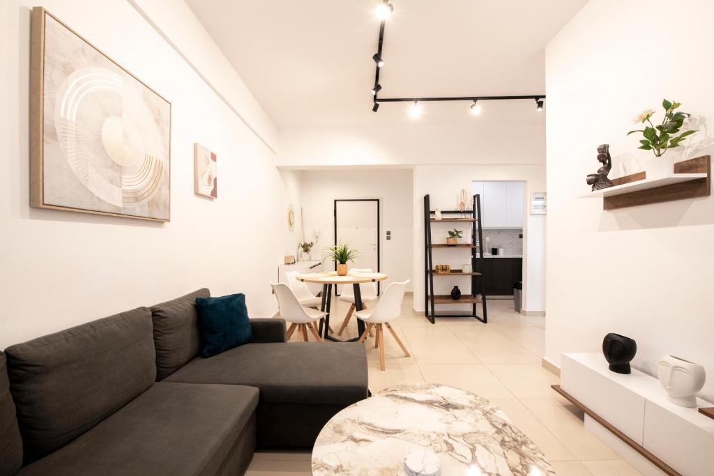 a living room with a couch and a table at Afroditi in Athens