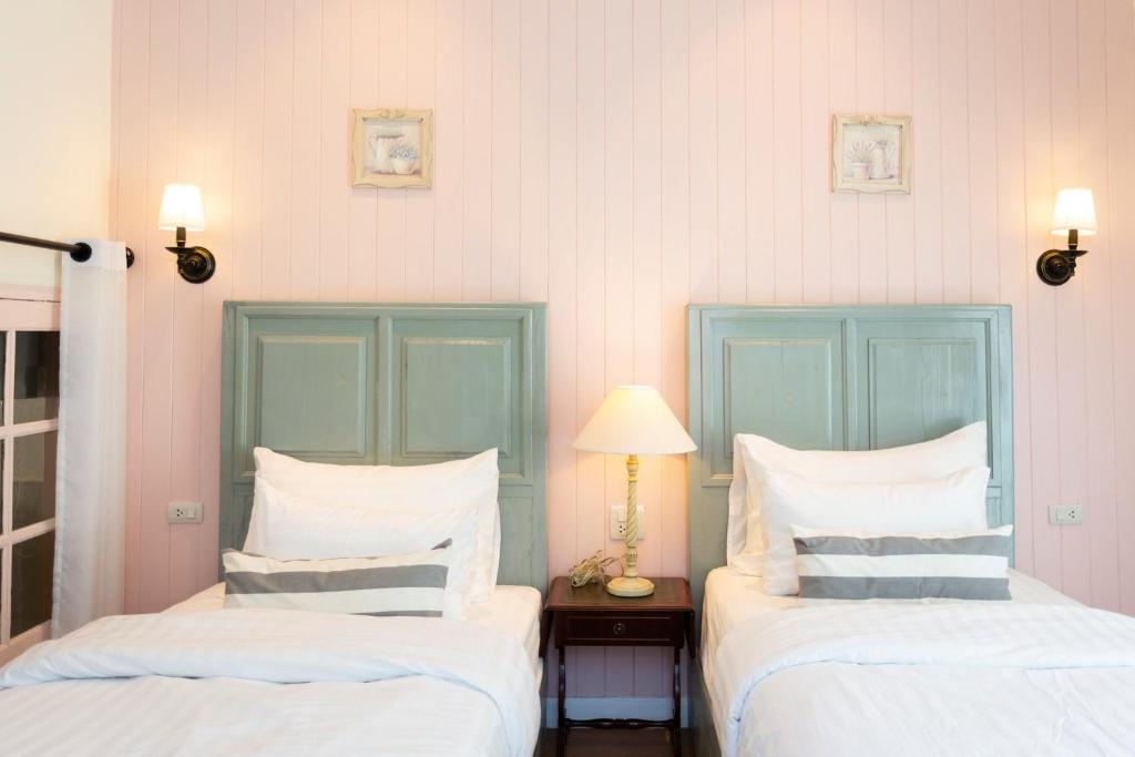 Postel nebo postele na pokoji v ubytování Nai Suan Bed and Breakfast