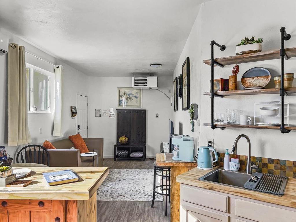 a kitchen and living room with a sink and a table at Quaint Monument Retreat studio in Grand Junction