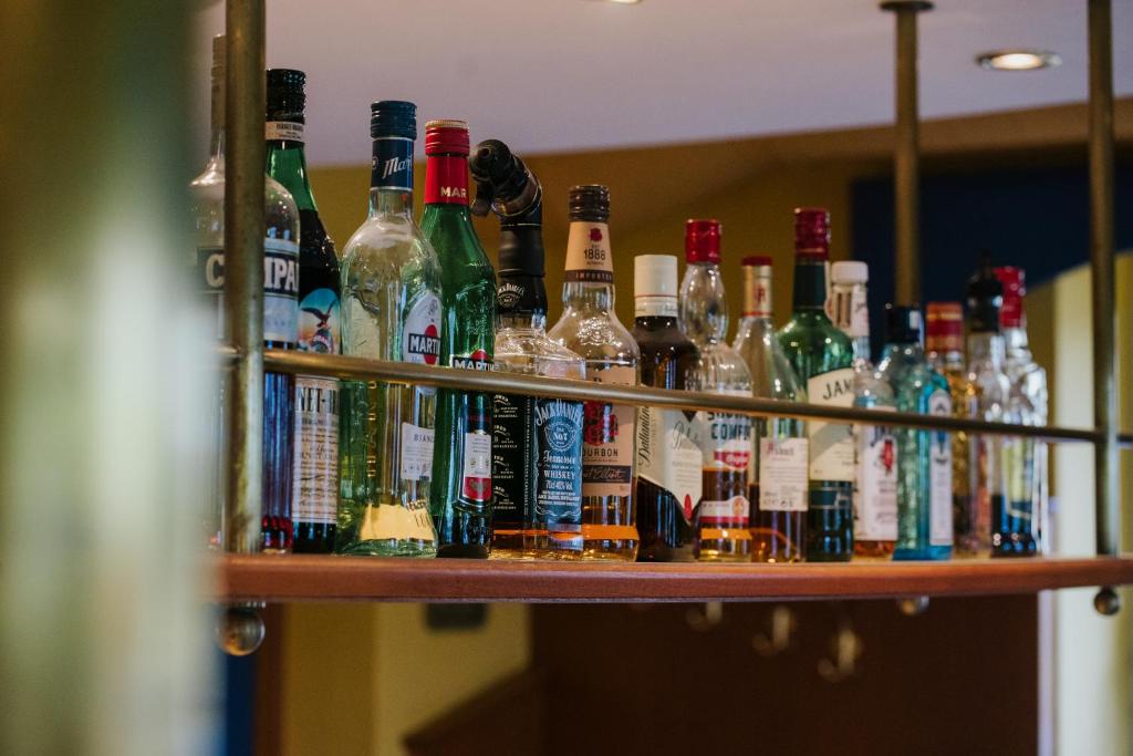 a shelf filled with lots of bottles of alcohol at Der Thomashof in Sankt Jakob im Rosental