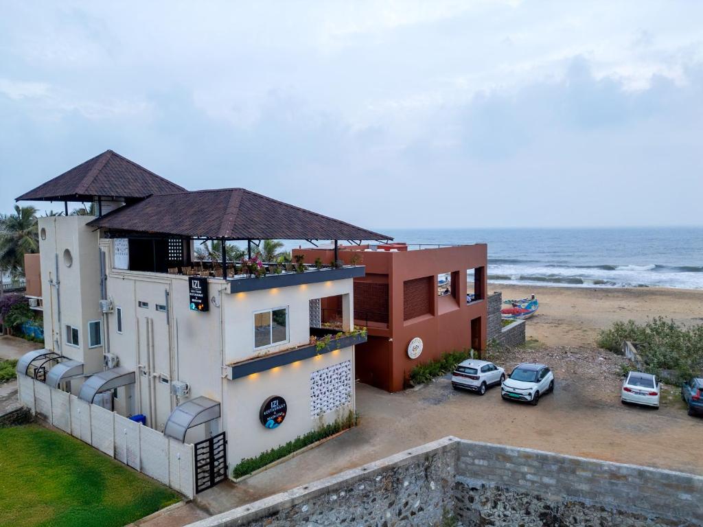 a building with a view of the ocean at IZI Beach Stay Mahabalipuram in Chennai