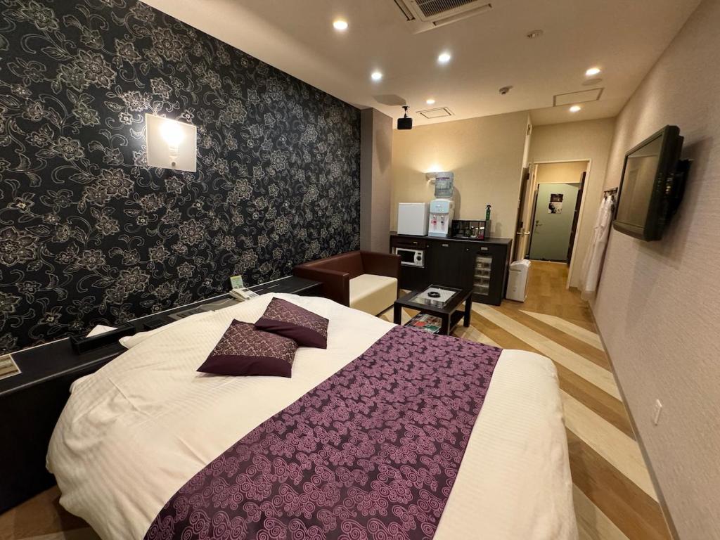 Postel nebo postele na pokoji v ubytování 艶横浜町田店 adult only