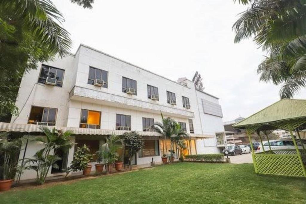 a white building with a yard in front of it at VITS Select Bharuch in Bharūch