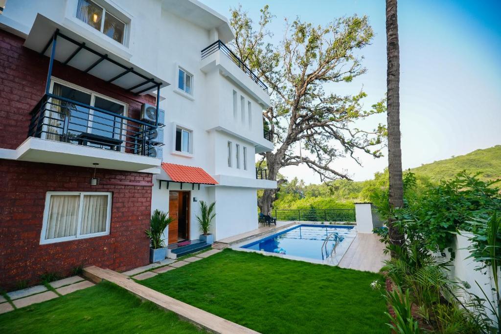 an image of a house with a swimming pool at Casa Das Imras Villa B in Calangute