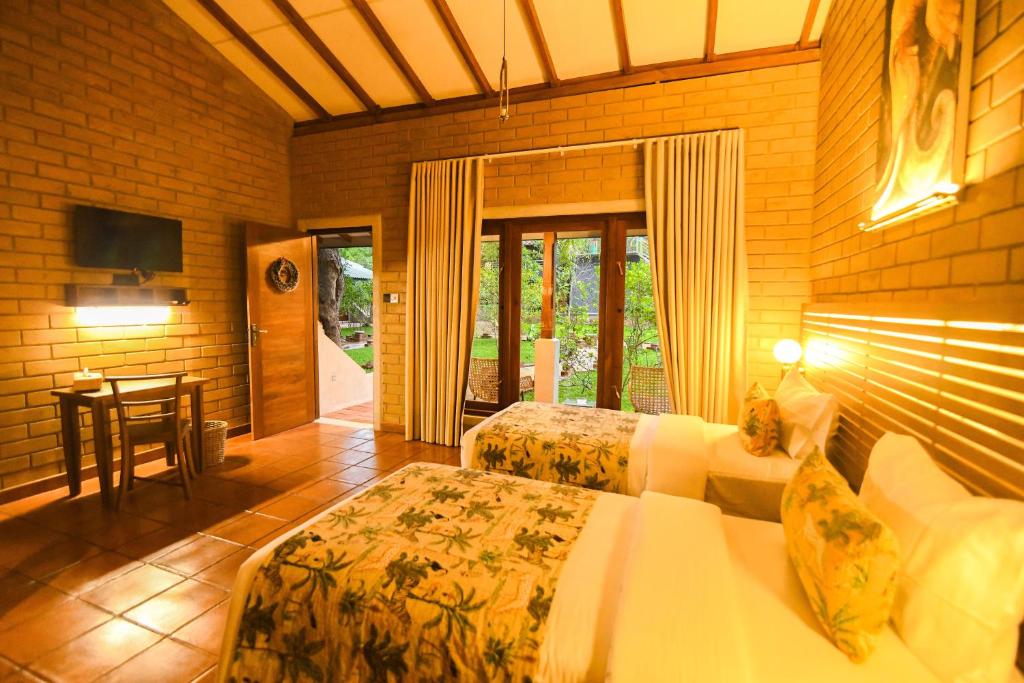 Postel nebo postele na pokoji v ubytování Dhalaya Resort Udawalawe