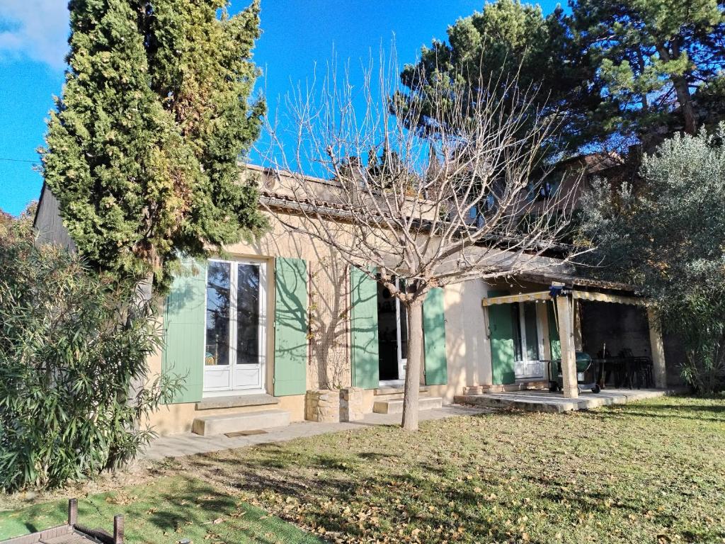 une maison verte avec un arbre en face dans l'établissement Villa Bellevue, Venterol 26110, à Venterol