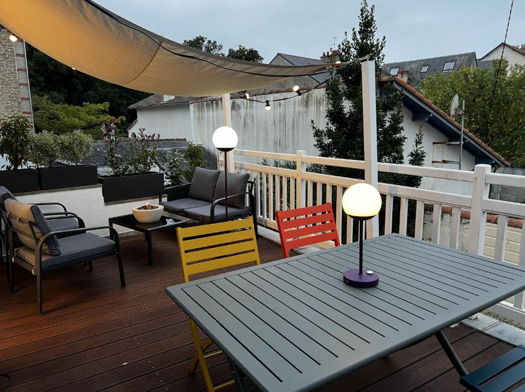 un patio avec une table et des chaises sur une terrasse dans l'établissement Appartement hyper centre, à Pornichet