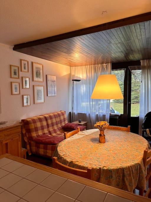 - un salon avec une table, une lampe et un canapé dans l'établissement Grazioso appartamento vicino alle piste, à Montgenèvre