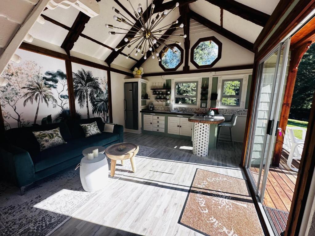 a living room with a couch and a table at Amazing Riverside Retreat with Hot Tub & EcoPool in Mossel Bay