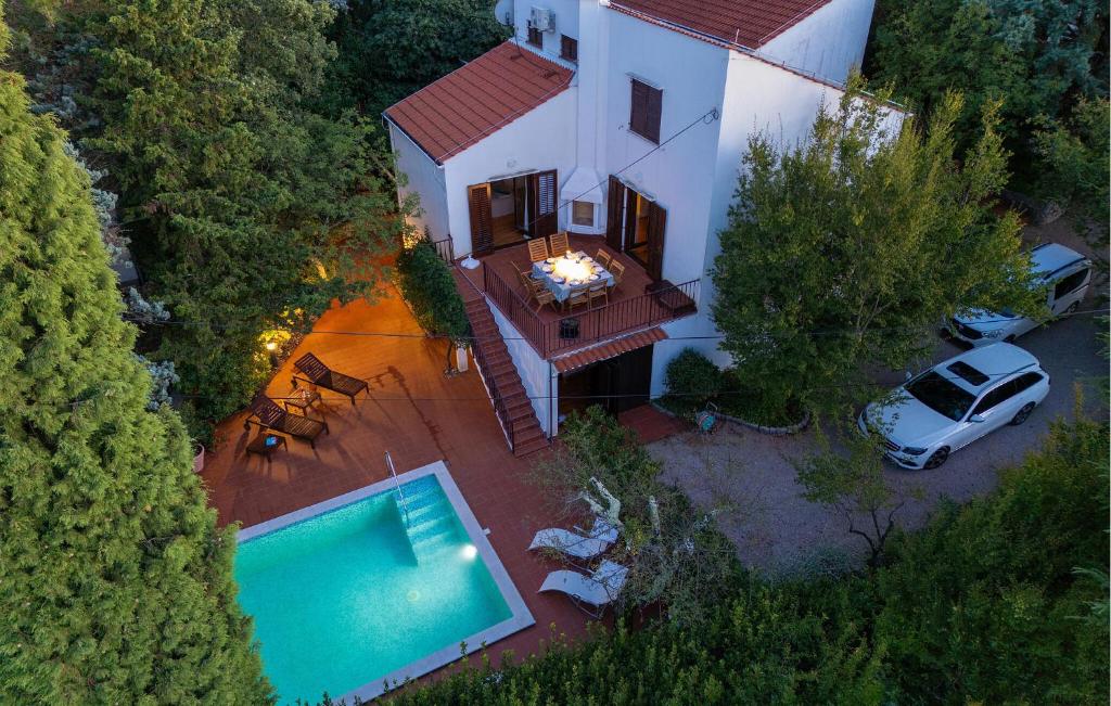 an aerial view of a house with a swimming pool at Beautiful Home In Malinska With Wifi in Malinska