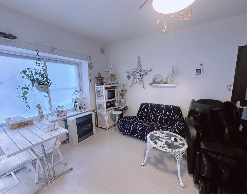 a living room with a couch and a table at 樽前の雪 in Otaru