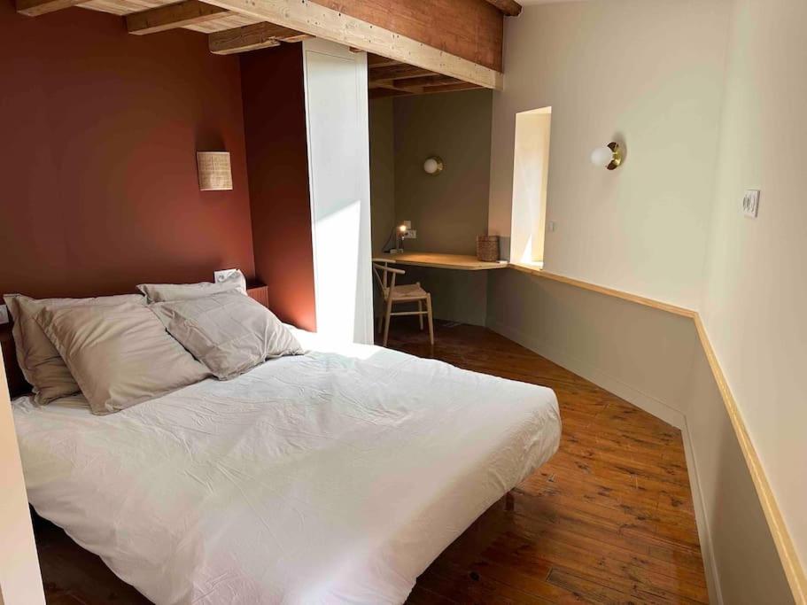 a bedroom with a white bed and a desk at Charmante maison de ville à 10' du centre de Lyon in Sainte-Foy-lès-Lyon