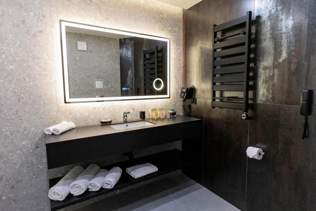 a bathroom with a sink and a mirror at MM Boutique Hotel in Burgas