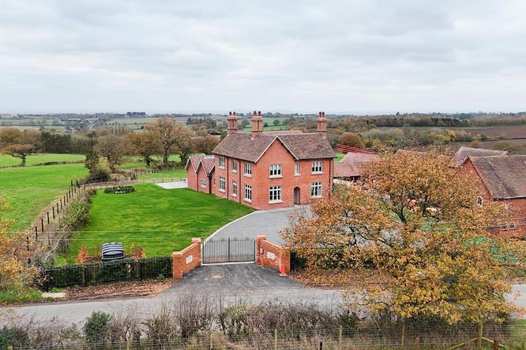 a large red brick house with a driveway at Grange House - Sleeps 24 in Alvechurch