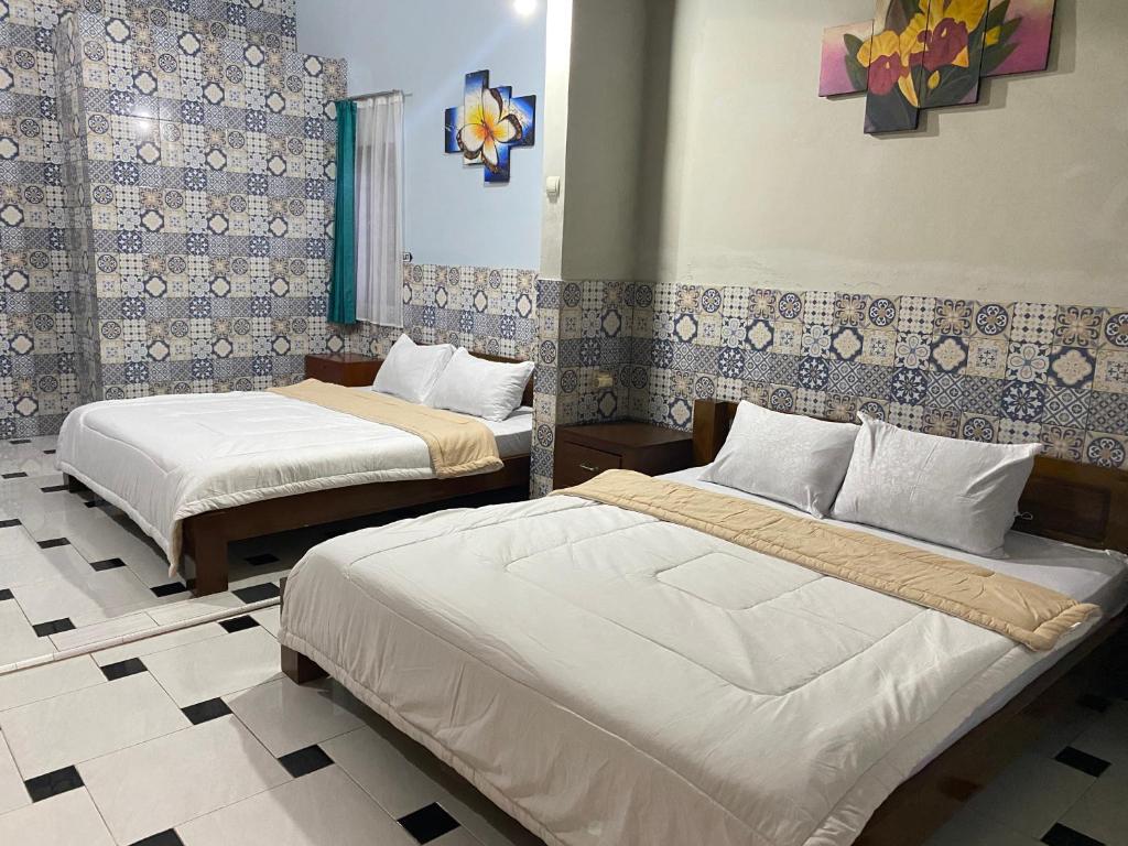 Postel nebo postele na pokoji v ubytování ADA Homestay