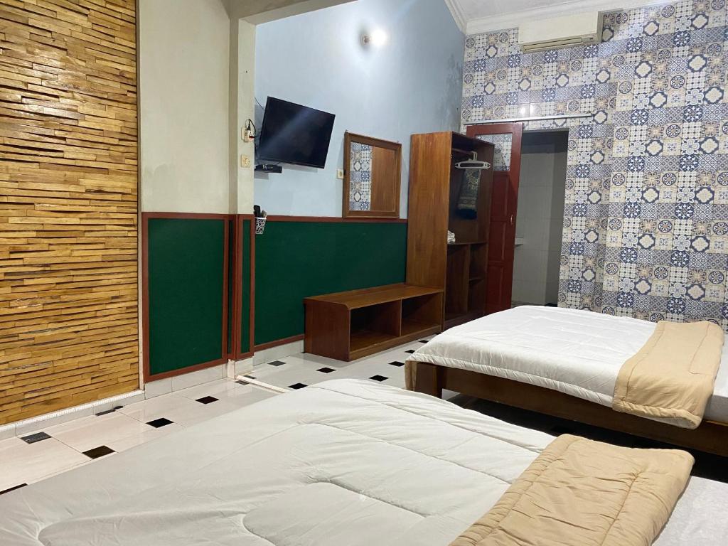 Postel nebo postele na pokoji v ubytování ADA Homestay