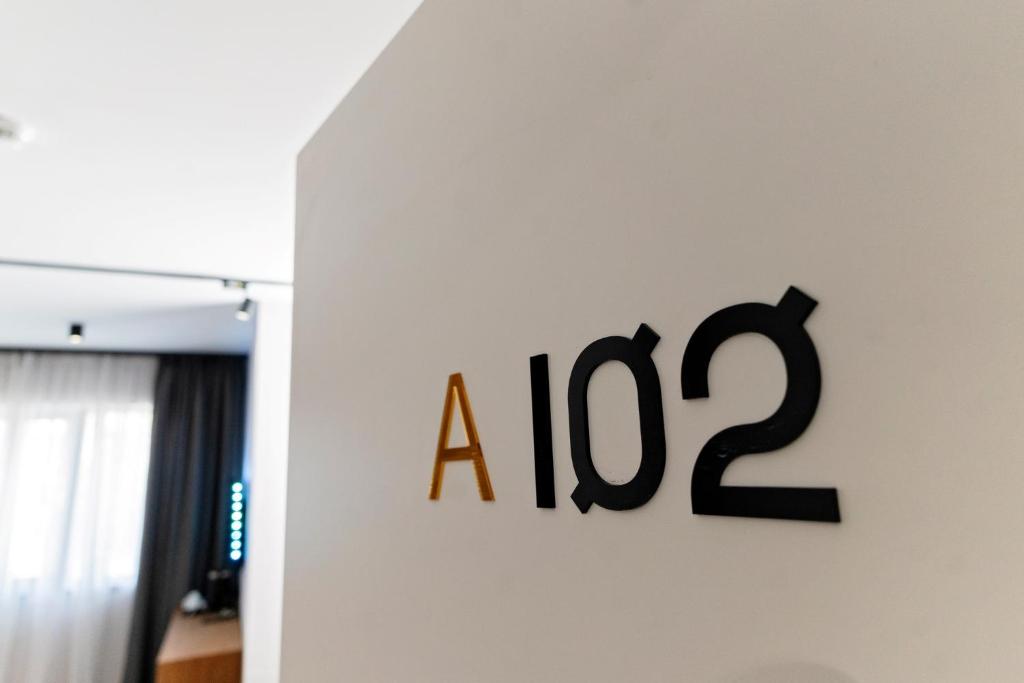 a sign on a wall with a on it at MM Boutique Hotel in Burgas