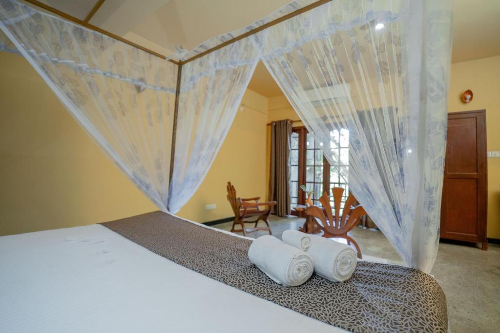 Postel nebo postele na pokoji v ubytování Manikgoda Tea Paradise