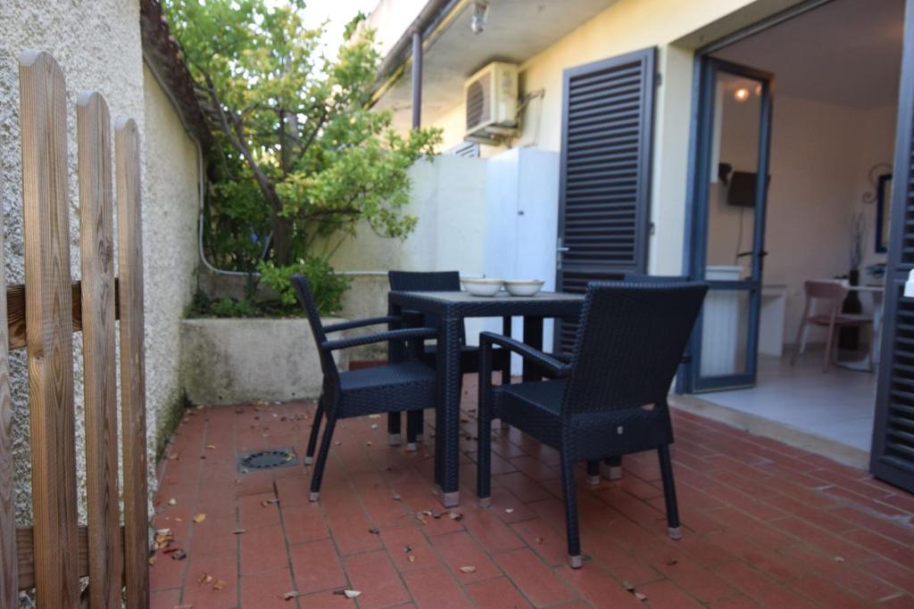 a black table and chairs on a patio at Mono ELBA in Marina di Campo