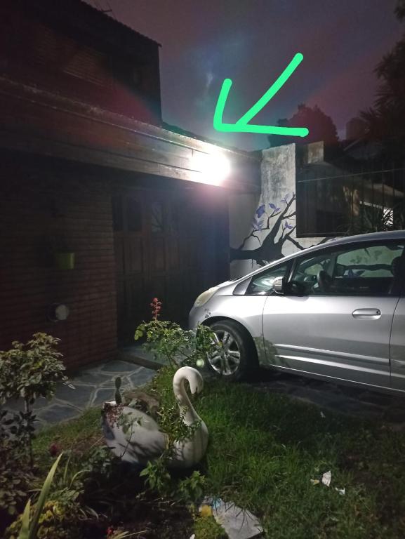 a car parked in front of a house with a x sign at departamento de 1 ambiente planta alta in Mar del Plata