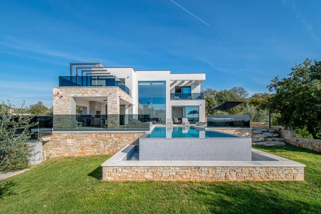 a house with a swimming pool in front of it at Villa Bella near Rovinj and Pula in Bale