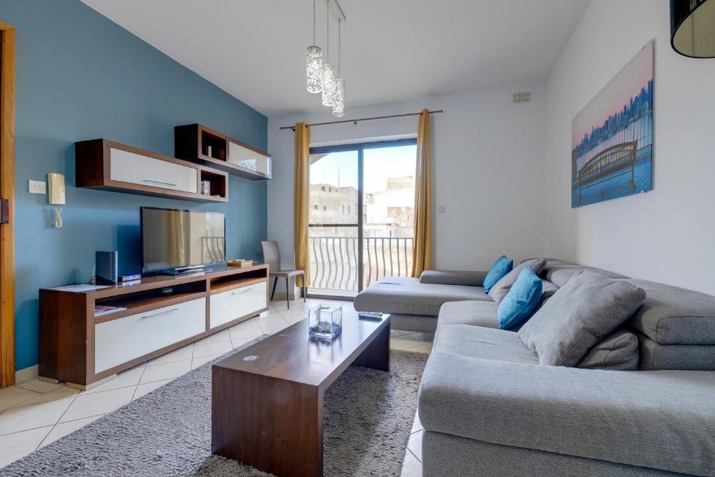 a living room with a couch and a coffee table at Modern 2BR Sliema Apartment in Sliema