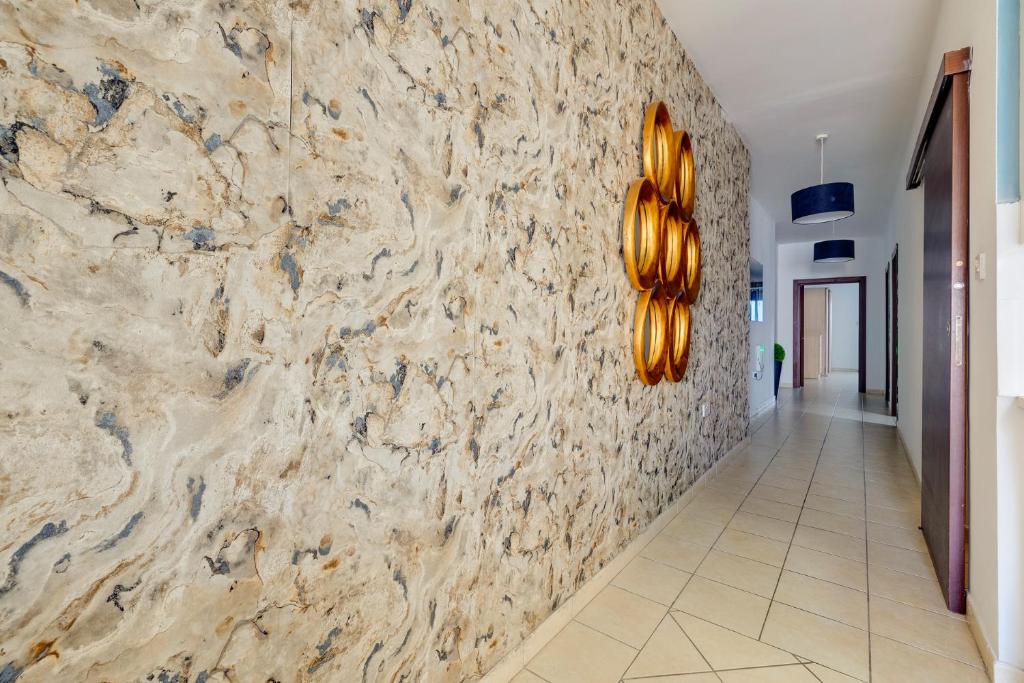 a hallway with a stone wall with donuts on it at Modern 2BR Sliema Apartment in Sliema