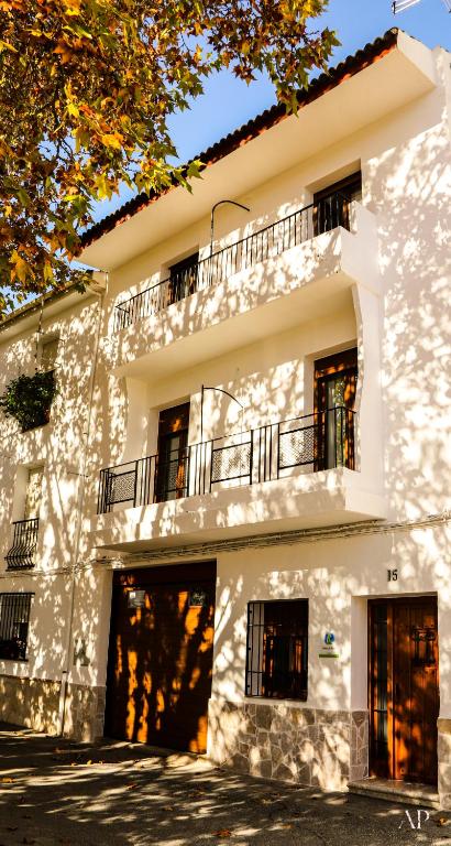 a large white building with a balcony on it at Escapada Rural en La Casa del Árbol in Tózar