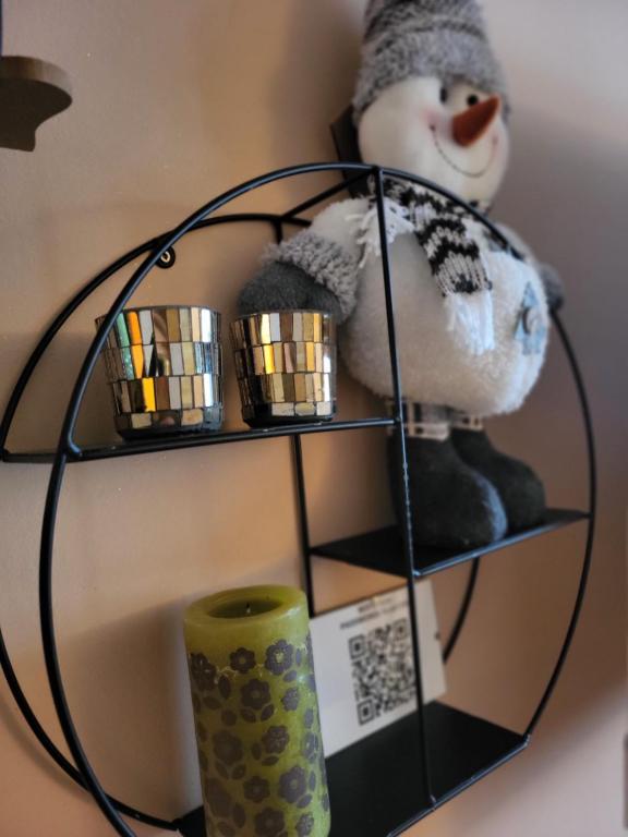 a shelf with a teddy bear and a candle at Eko FIS Snowscape in Šišava