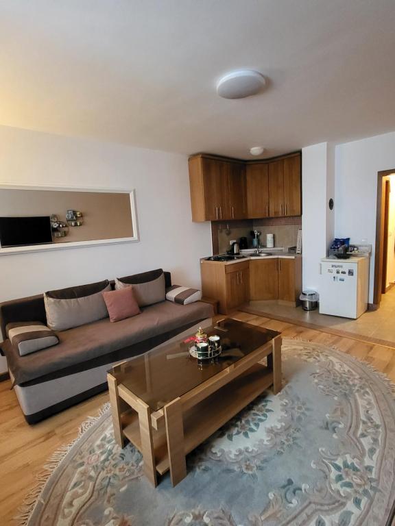 a living room with a couch and a table at Eko FIS Snowscape in Šišava