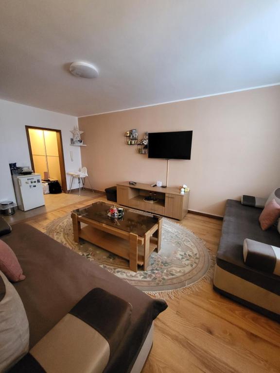 a living room with a couch and a coffee table at Eko FIS Snowscape in Šišava
