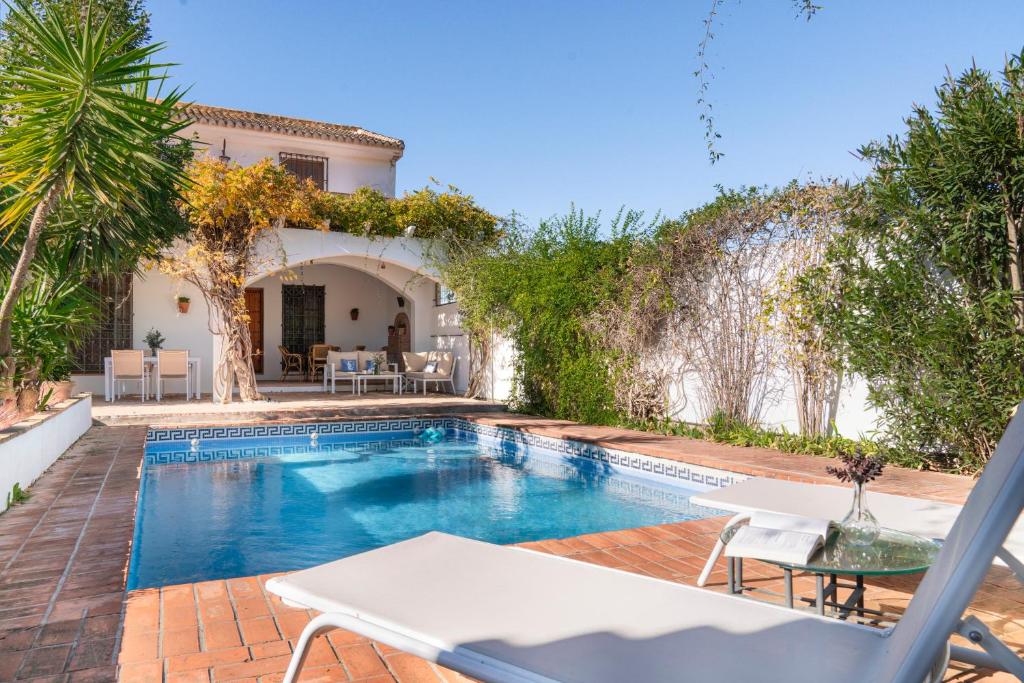 a villa with a swimming pool and a house at Casa rural Buenos Días con piscina, barbaco y chimenea in Padul