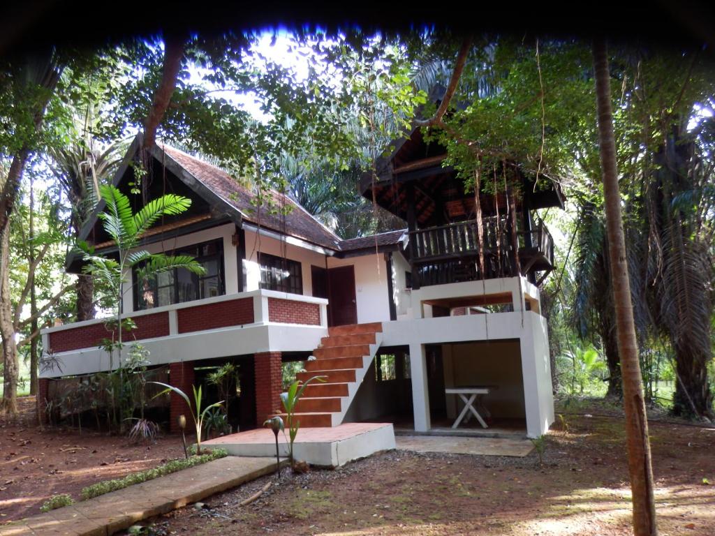 a house in the woods with a staircase leading to it at Koh Mak 7 in Ko Mak
