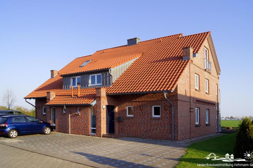 a brick house with an orange roof at 20 Ferienwohnung im Fritz-Bleyl-Weg 16a OG in Burg auf Fehmarn