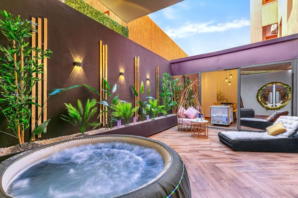 a hot tub in the middle of a room with plants at Villa YOGA Guéliz Centre-Ville in Marrakech