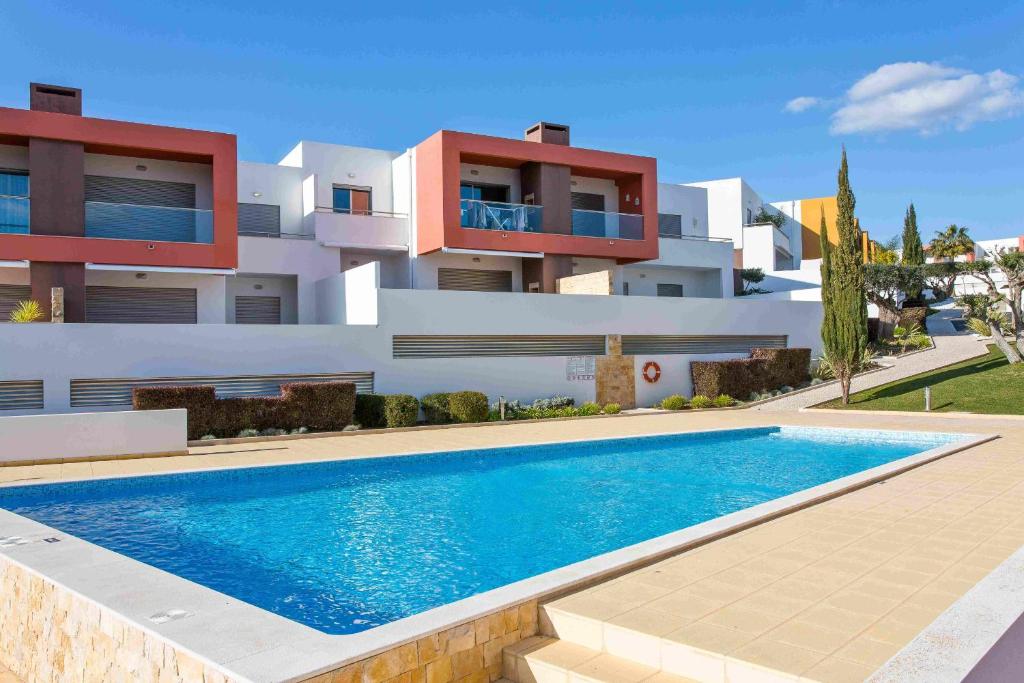 a house with a swimming pool in front of it at Albufeira Sunny Apartment 3 With Pool by Homing in Albufeira