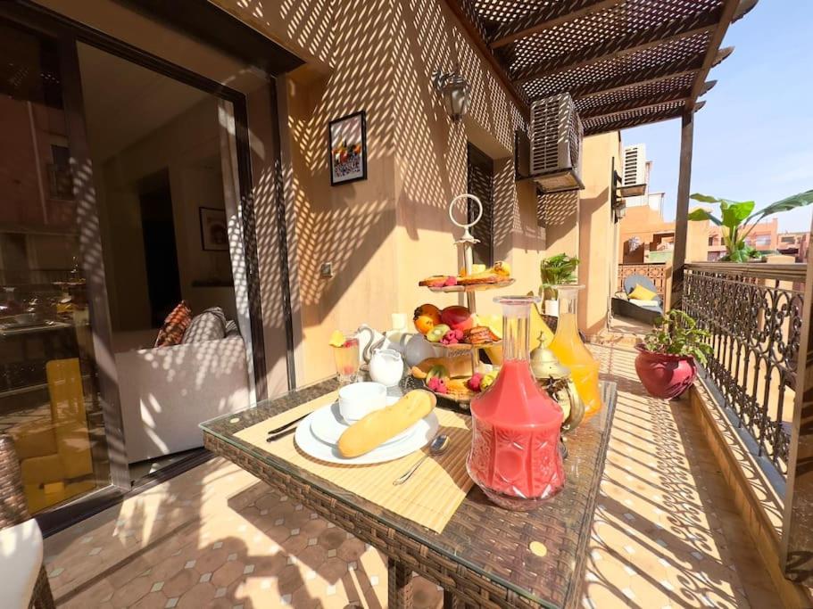 a table with a plate of fruit on a balcony at Piscine Guéliz Center Yoga in Marrakech