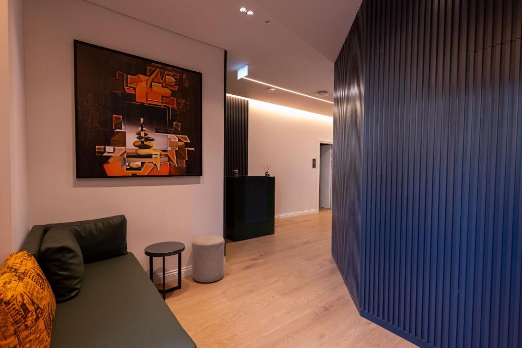 a living room with a couch and a painting on the wall at Summer Depo in Sarandë